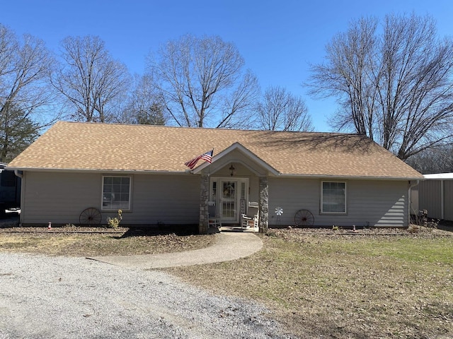 single story home with driveway and roof with shingles