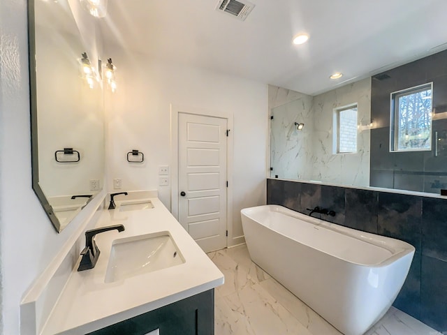 bathroom with visible vents, marble finish floor, and a sink