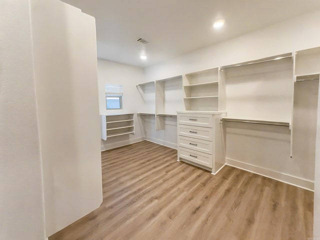 spacious closet featuring visible vents and light wood-style flooring