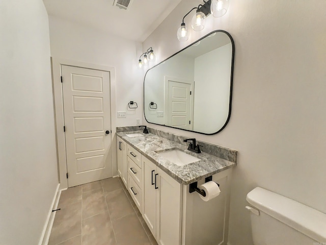 bathroom featuring tile patterned flooring, visible vents, toilet, and a sink