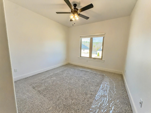 unfurnished room featuring baseboards and a ceiling fan