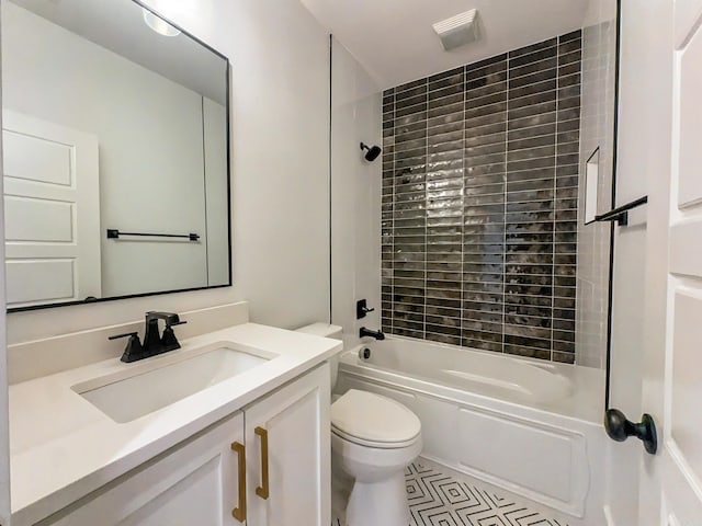 bathroom featuring bathing tub / shower combination, toilet, vanity, and tile patterned flooring