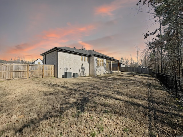 exterior space featuring central AC unit and a fenced backyard