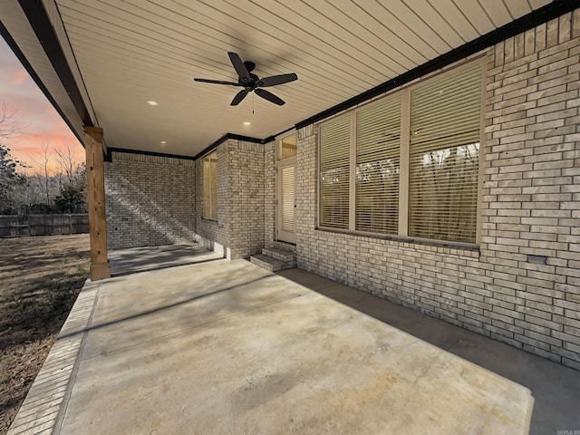 view of patio with entry steps, a ceiling fan, and fence