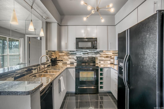 kitchen with decorative backsplash, black appliances, white cabinetry, and a sink