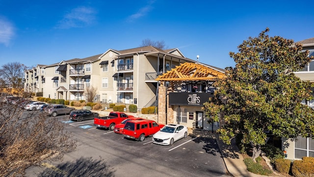 view of building exterior featuring uncovered parking