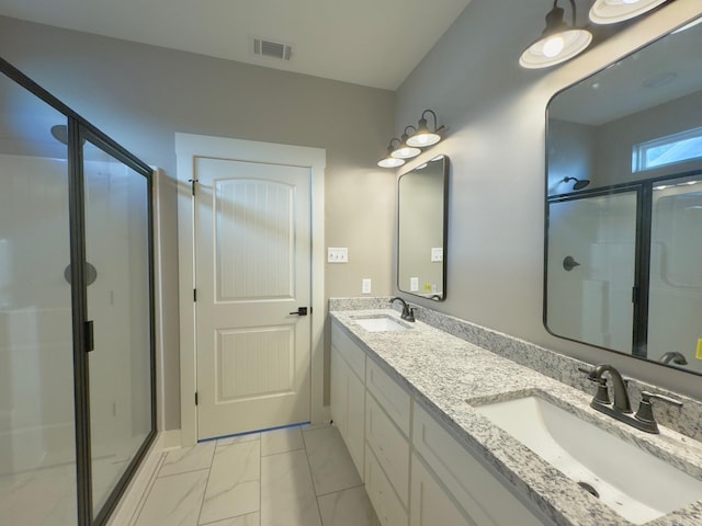 bathroom with visible vents, marble finish floor, a stall shower, and a sink