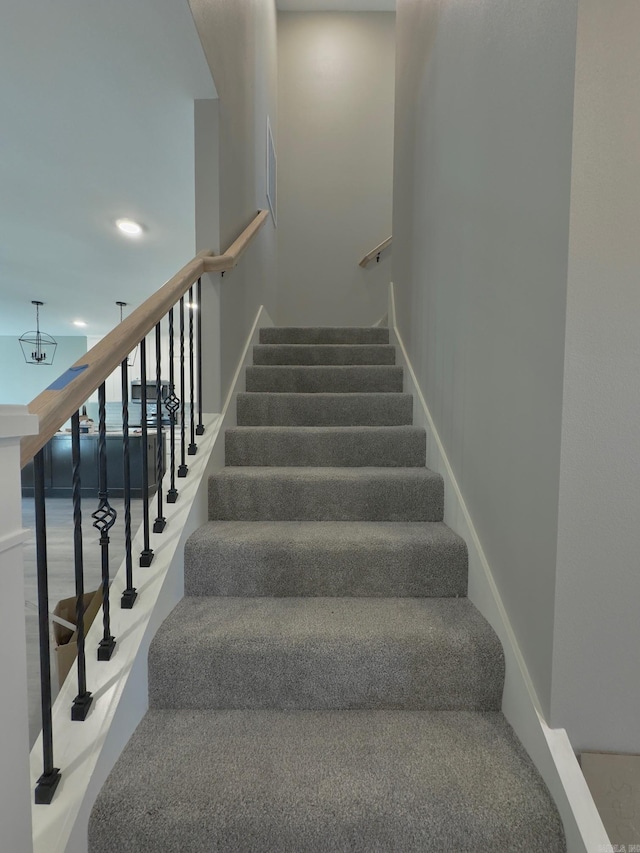 staircase with visible vents and baseboards