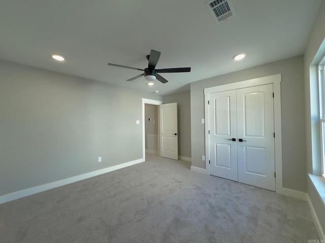 unfurnished bedroom featuring visible vents, recessed lighting, carpet, and baseboards