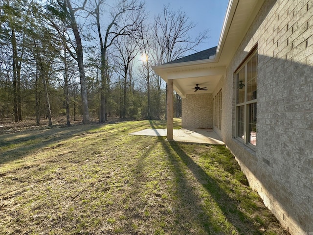 view of yard featuring a patio area and a ceiling fan