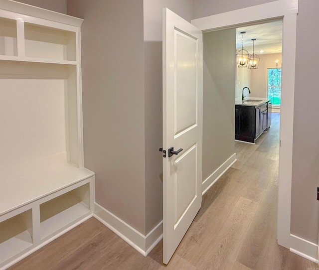 1275 Acuff Ln, Conway, AR 72034 - mudroom with light wood-style floors, an inviting chandelier, a sink, and baseboards