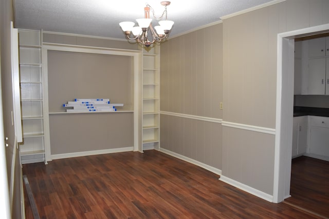 unfurnished dining area featuring an inviting chandelier, crown molding, baseboards, and dark wood-style flooring