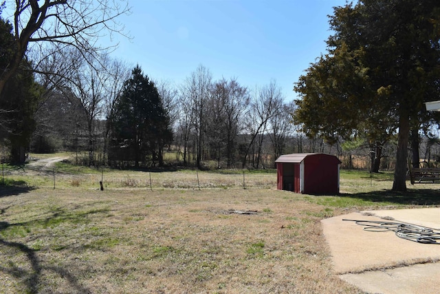 view of yard featuring a storage shed and an outbuilding