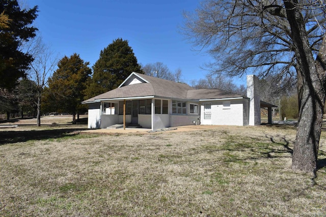 view of front of property with a front yard and a sunroom