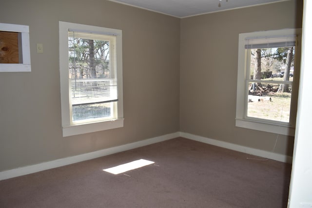 carpeted empty room with baseboards