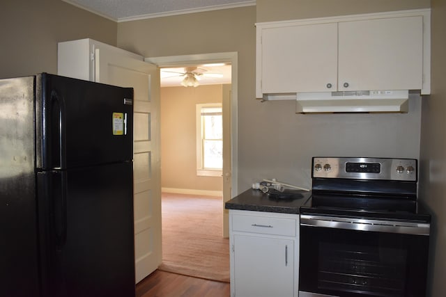 kitchen with under cabinet range hood, white cabinets, stainless steel range with electric stovetop, and freestanding refrigerator