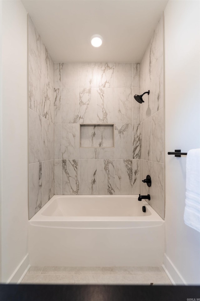 bathroom featuring baseboards and shower / washtub combination