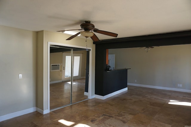 interior space featuring a ceiling fan and baseboards