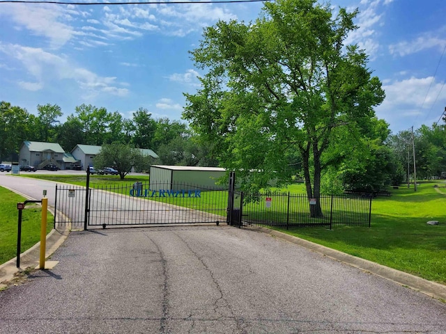 view of gate featuring a yard and fence