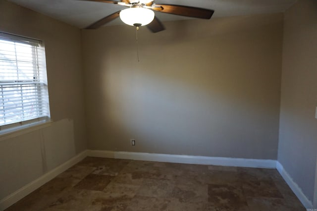 unfurnished room featuring baseboards and a ceiling fan