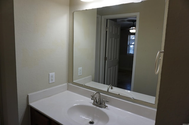 bathroom featuring vanity and a textured wall