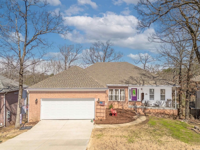 ranch-style house with covered porch, concrete driveway, an attached garage, a shingled roof, and brick siding