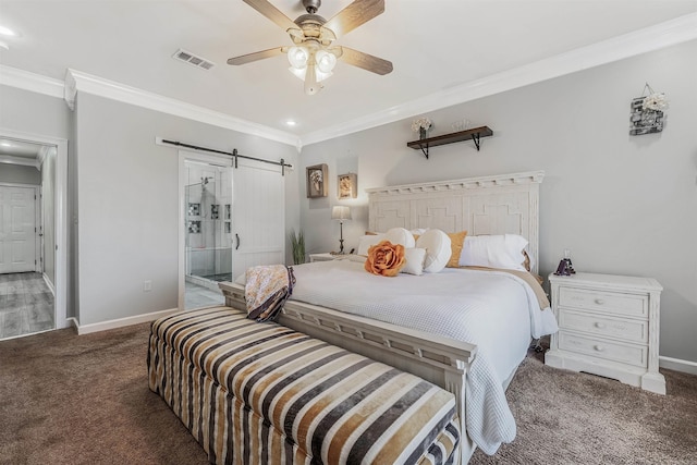 bedroom featuring visible vents, crown molding, baseboards, a barn door, and carpet flooring