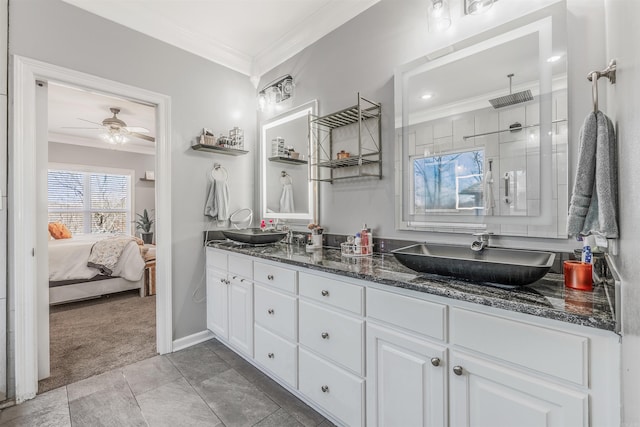 full bath featuring double vanity, a tile shower, crown molding, and a sink