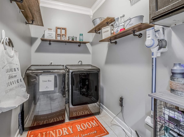 laundry area featuring washer and clothes dryer, light tile patterned floors, baseboards, and ornamental molding