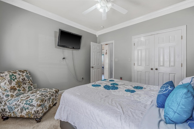 carpeted bedroom featuring a closet, a ceiling fan, and crown molding