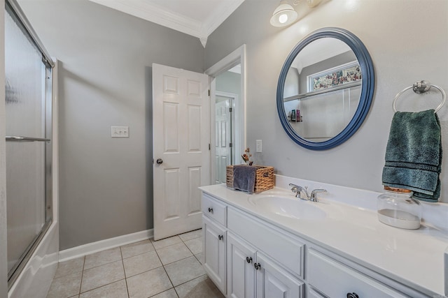 bathroom with tile patterned floors, vanity, crown molding, baseboards, and bath / shower combo with glass door