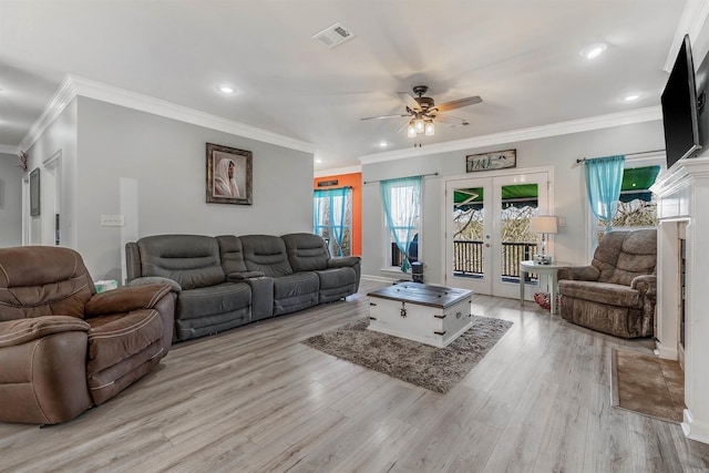 living area featuring light wood-style floors, recessed lighting, french doors, and visible vents