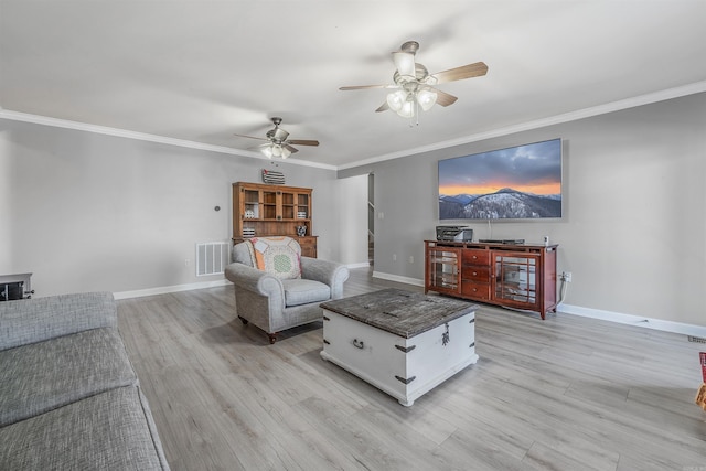 living area with crown molding, baseboards, visible vents, and light wood finished floors