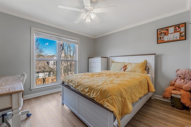 bedroom with baseboards, wood finished floors, and crown molding