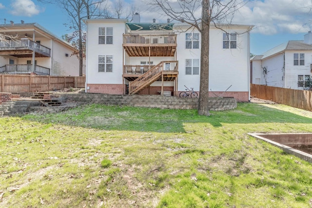 back of house featuring a lawn and fence