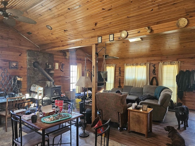 living area featuring wooden walls and a ceiling fan