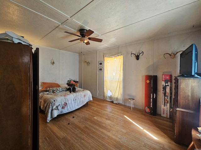 bedroom with ceiling fan and wood finished floors