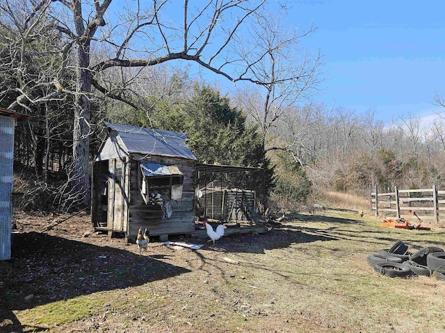 view of yard with an outdoor structure and fence