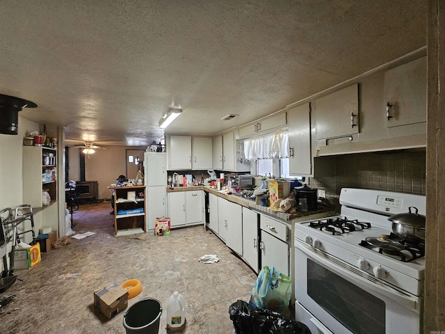 kitchen with white cabinetry, white range with gas cooktop, under cabinet range hood, and a textured ceiling