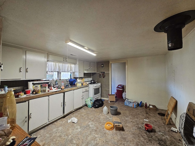 kitchen with white cabinets, heating unit, white gas range, and a textured ceiling