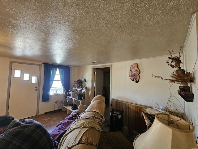 living area featuring visible vents and a textured ceiling