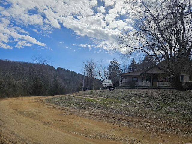 view of road featuring a wooded view