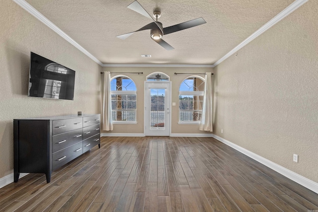 interior space with dark wood-style floors, crown molding, and a textured wall