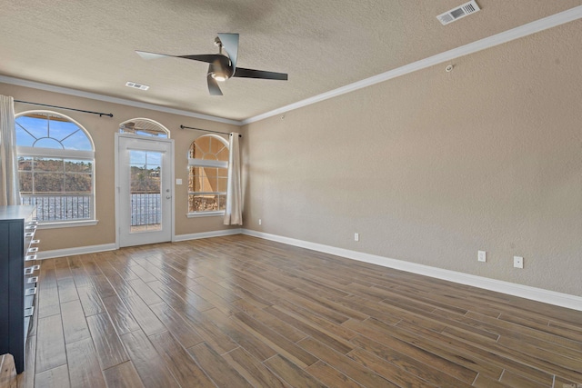 spare room with visible vents, a textured ceiling, wood finished floors, crown molding, and ceiling fan