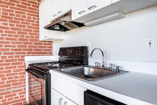 kitchen featuring stainless steel electric range oven, brick wall, a sink, under cabinet range hood, and white cabinetry