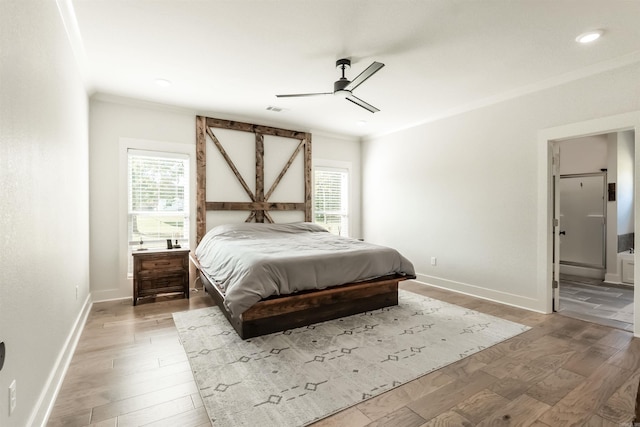 bedroom with multiple windows, ornamental molding, and light wood finished floors