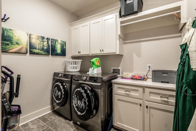 laundry room with baseboards, cabinet space, and independent washer and dryer