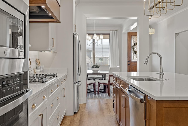 kitchen with crown molding, brown cabinetry, appliances with stainless steel finishes, custom exhaust hood, and a sink