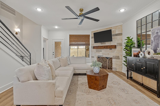 living room with visible vents, a healthy amount of sunlight, and crown molding