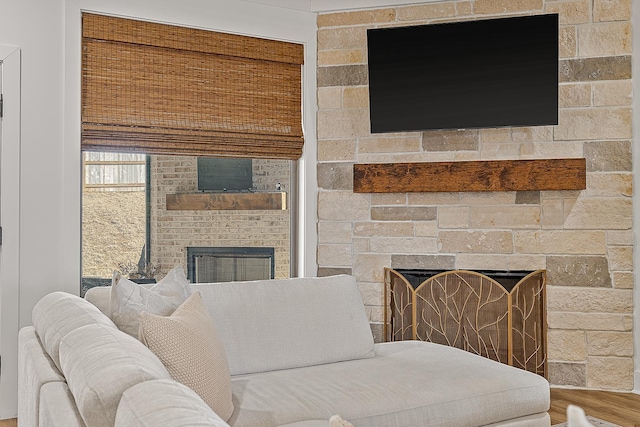 living area featuring a fireplace and wood finished floors